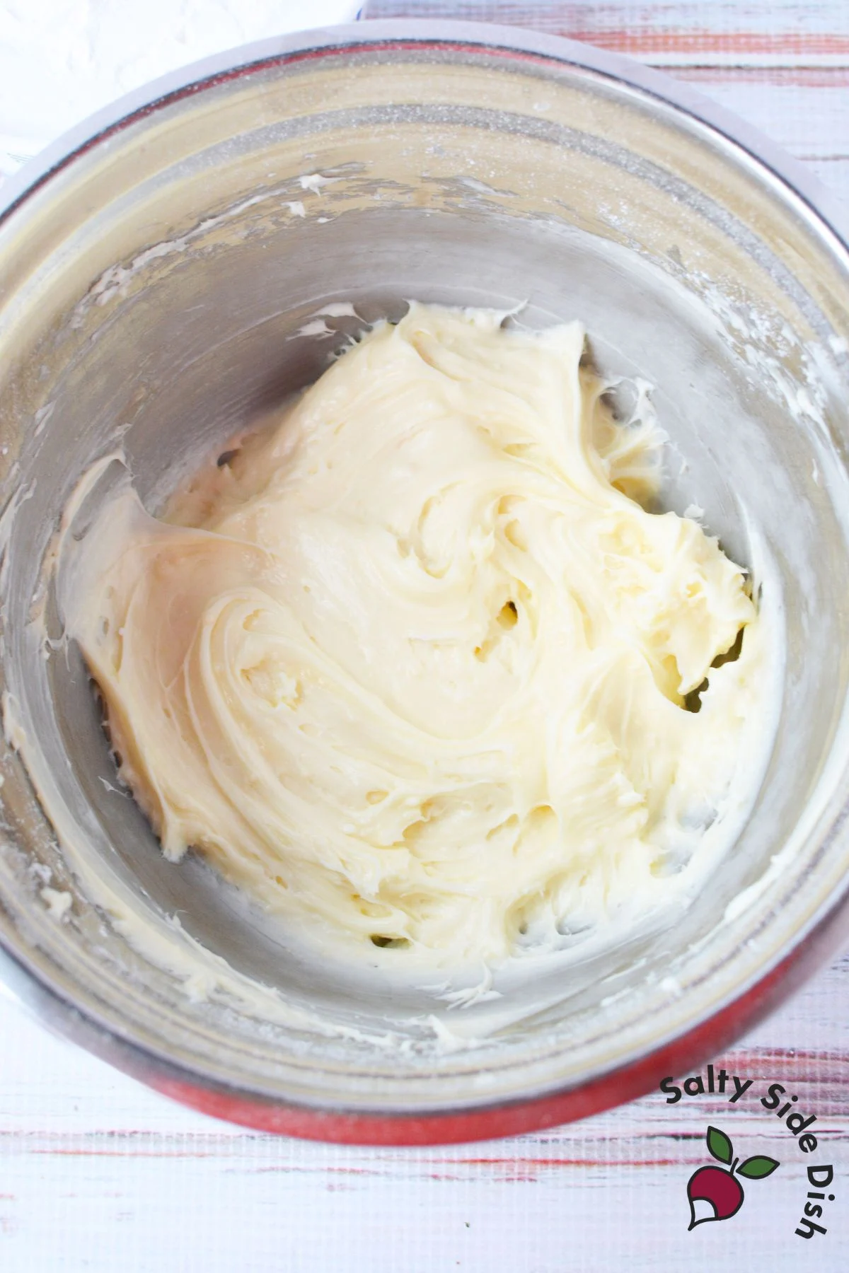 mixing bowl with softened cream cheese, powdered sugar, and vanilla extract