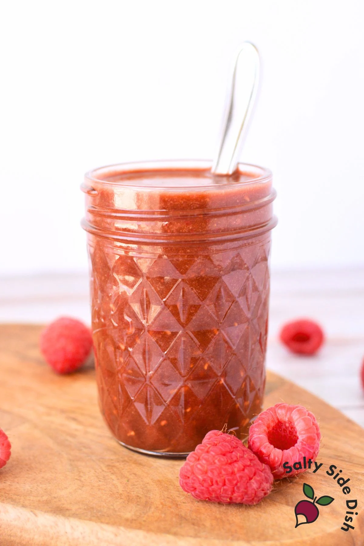 jar of raspberry dressing on a table.