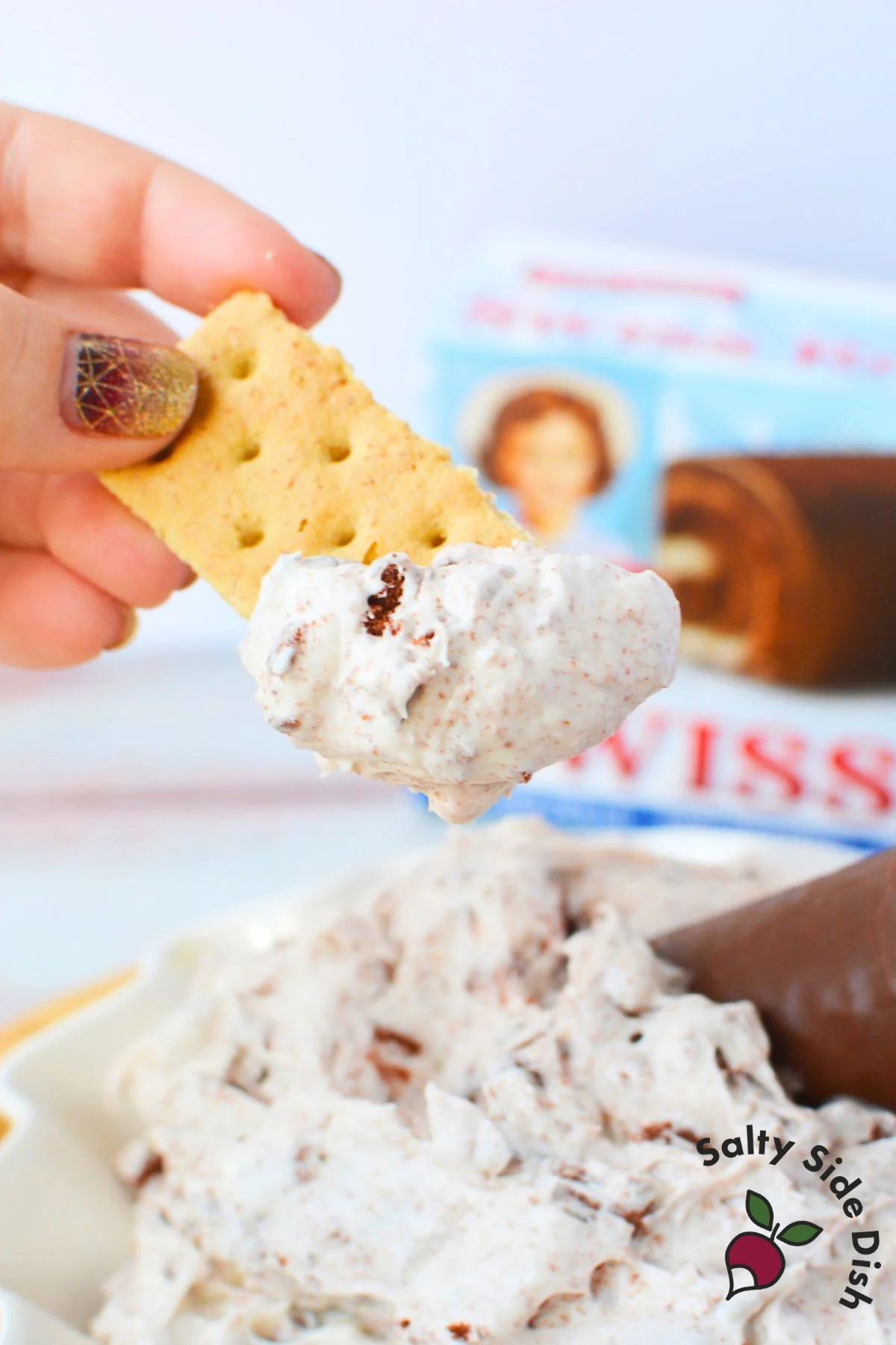 dipping dip with a graham cracker.