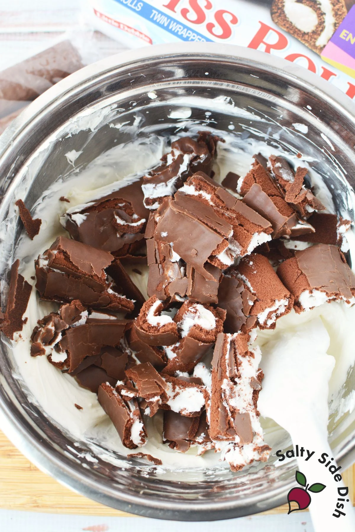 mixing in little debbie swiss rolls into a dessert dip base.