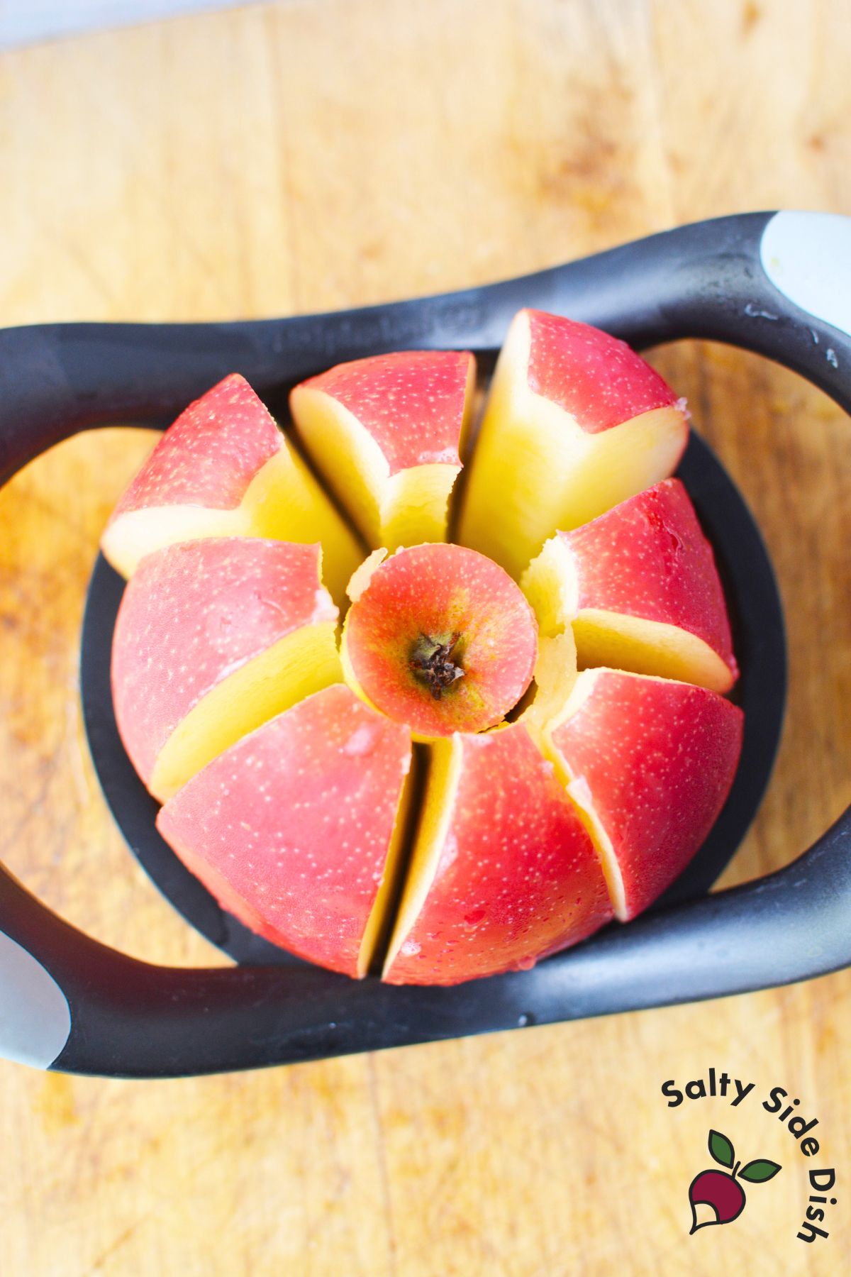 red apples being cut down by an apple corer.