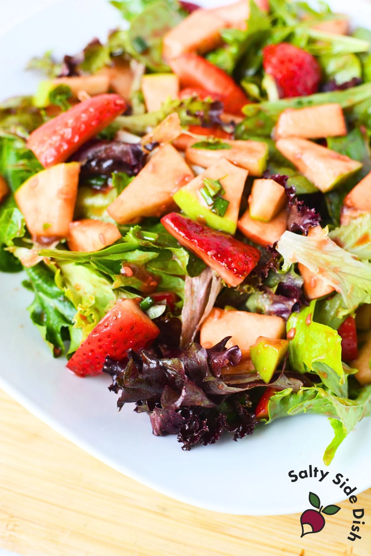 spinach salad with strawberries and apples.