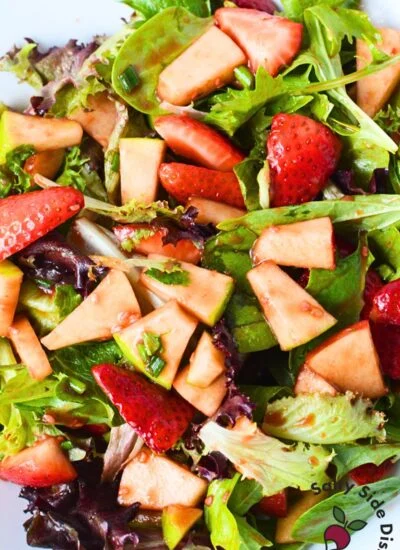 strawberry spinach salad in a bowl.