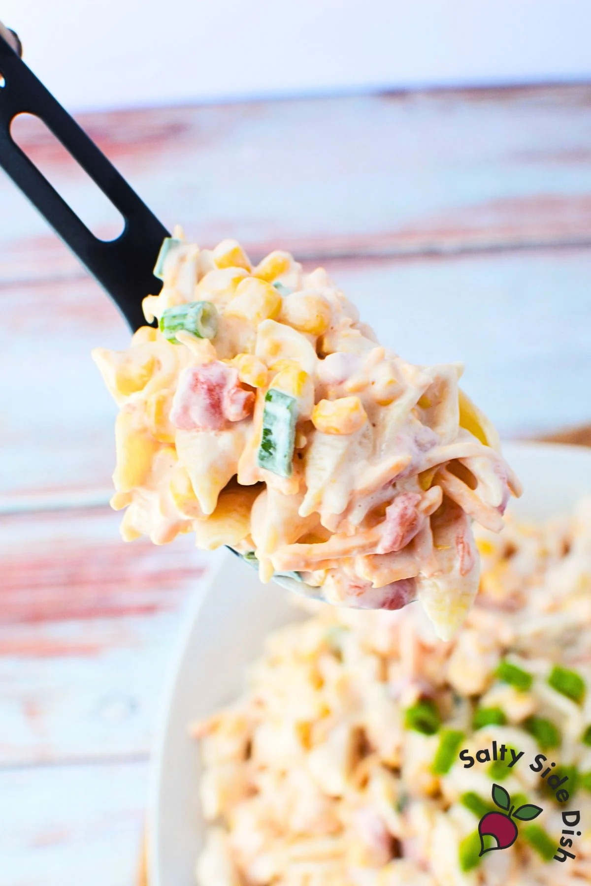corn pasta salad on a spoon.