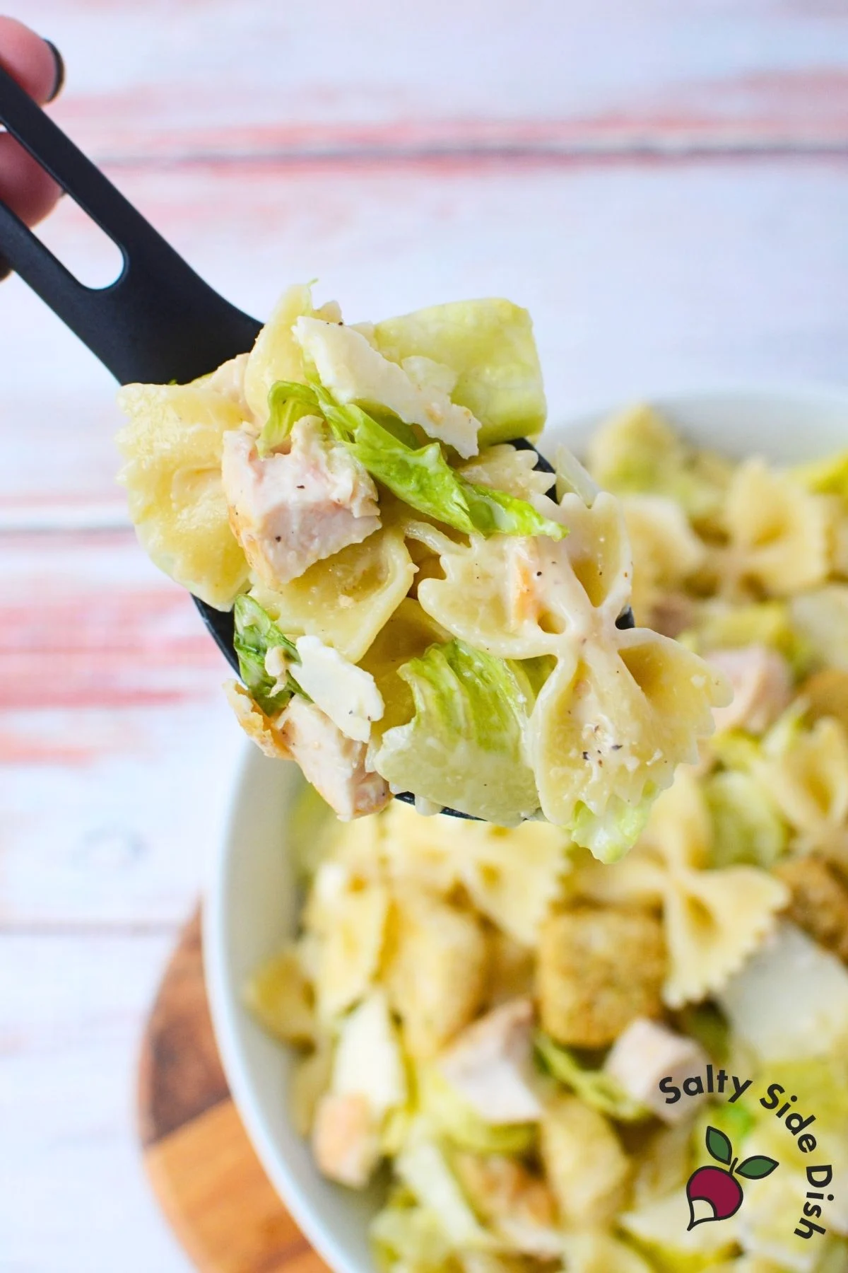 pasta salad on a serving spoon.