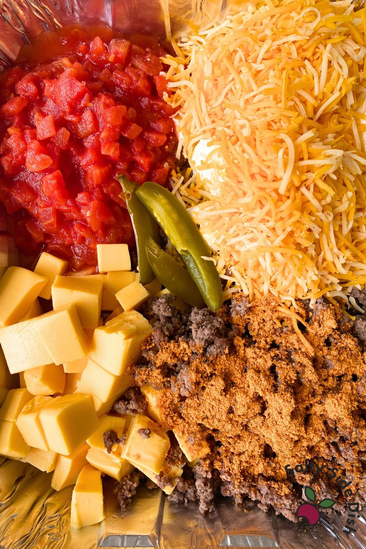 close up of smoked queso ingredients in a disposable pan.