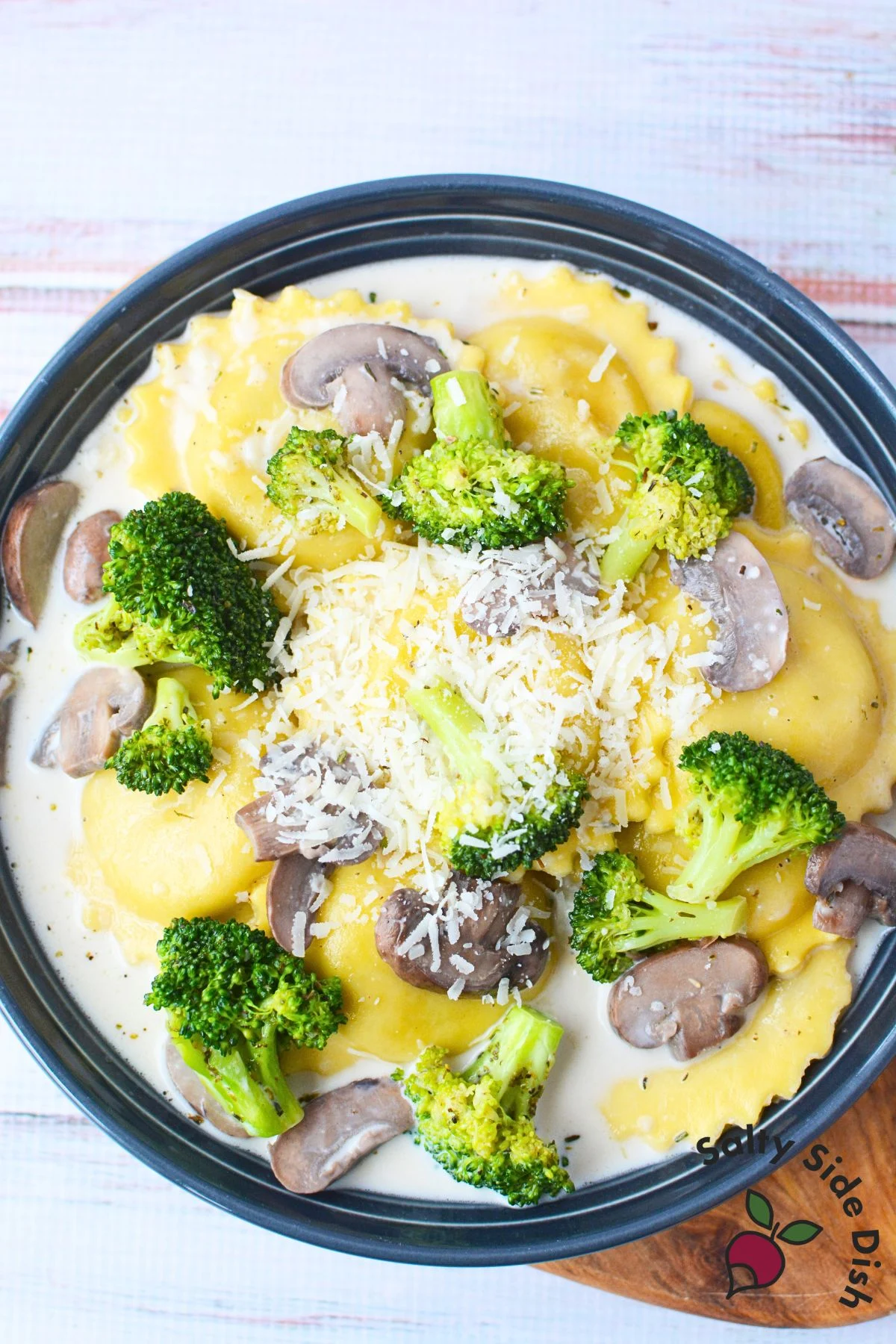 cast iron pan with ravioli in cream sauce.
