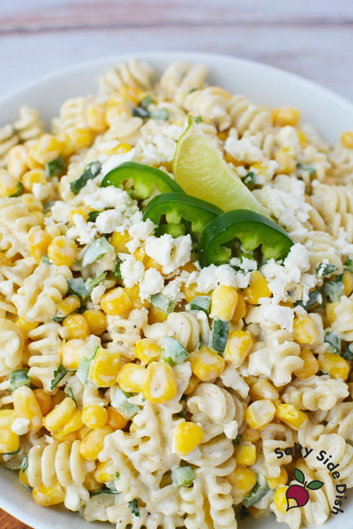 corn, pasta, feta cheese, and jalapenos in a pasta salad.
