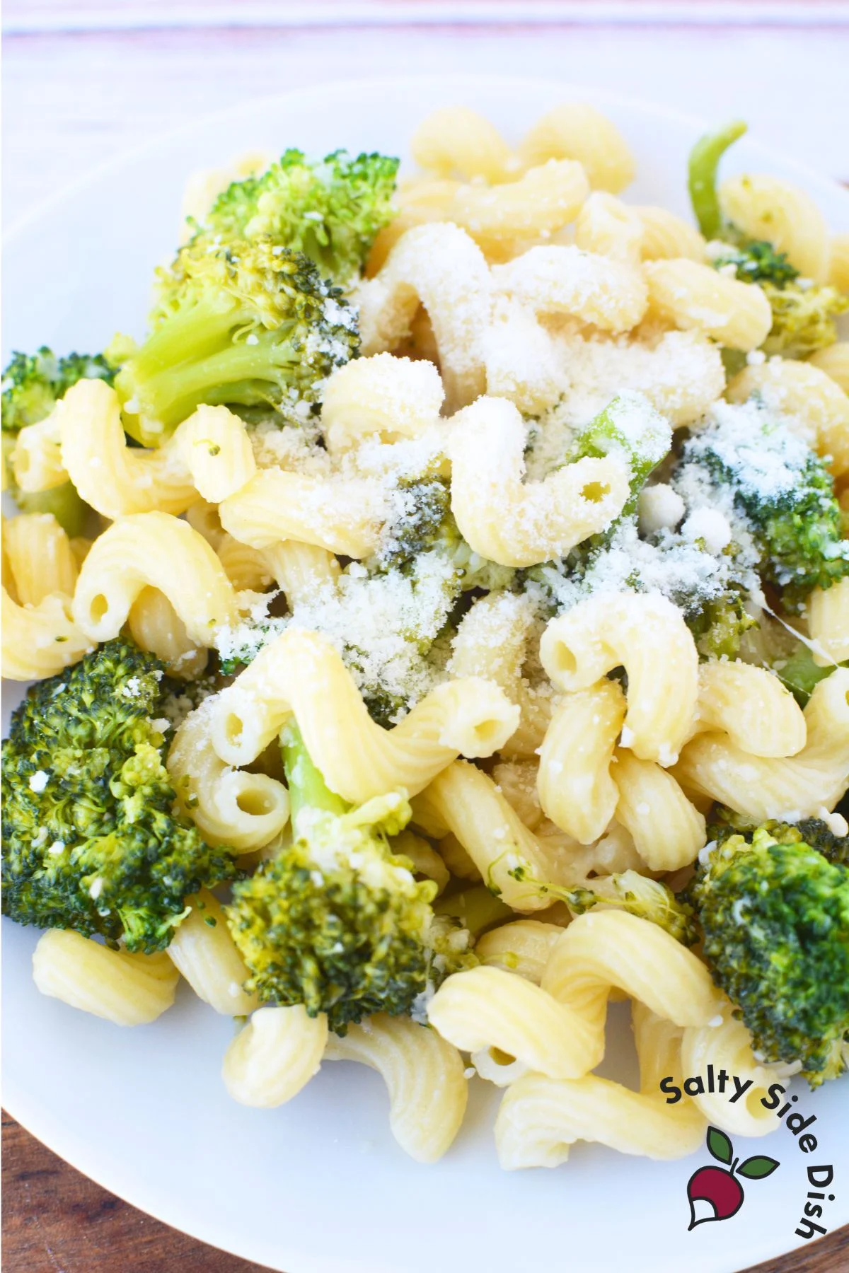 adding extra parmesan on top of dish.