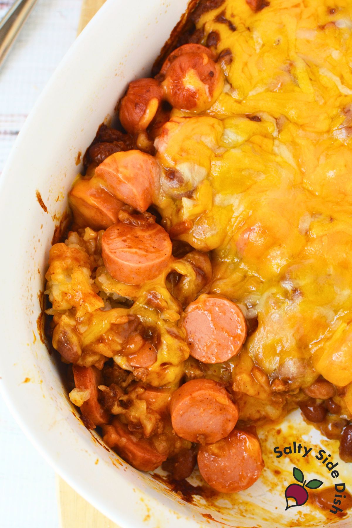 chili cheese dog casserole in a white dish.