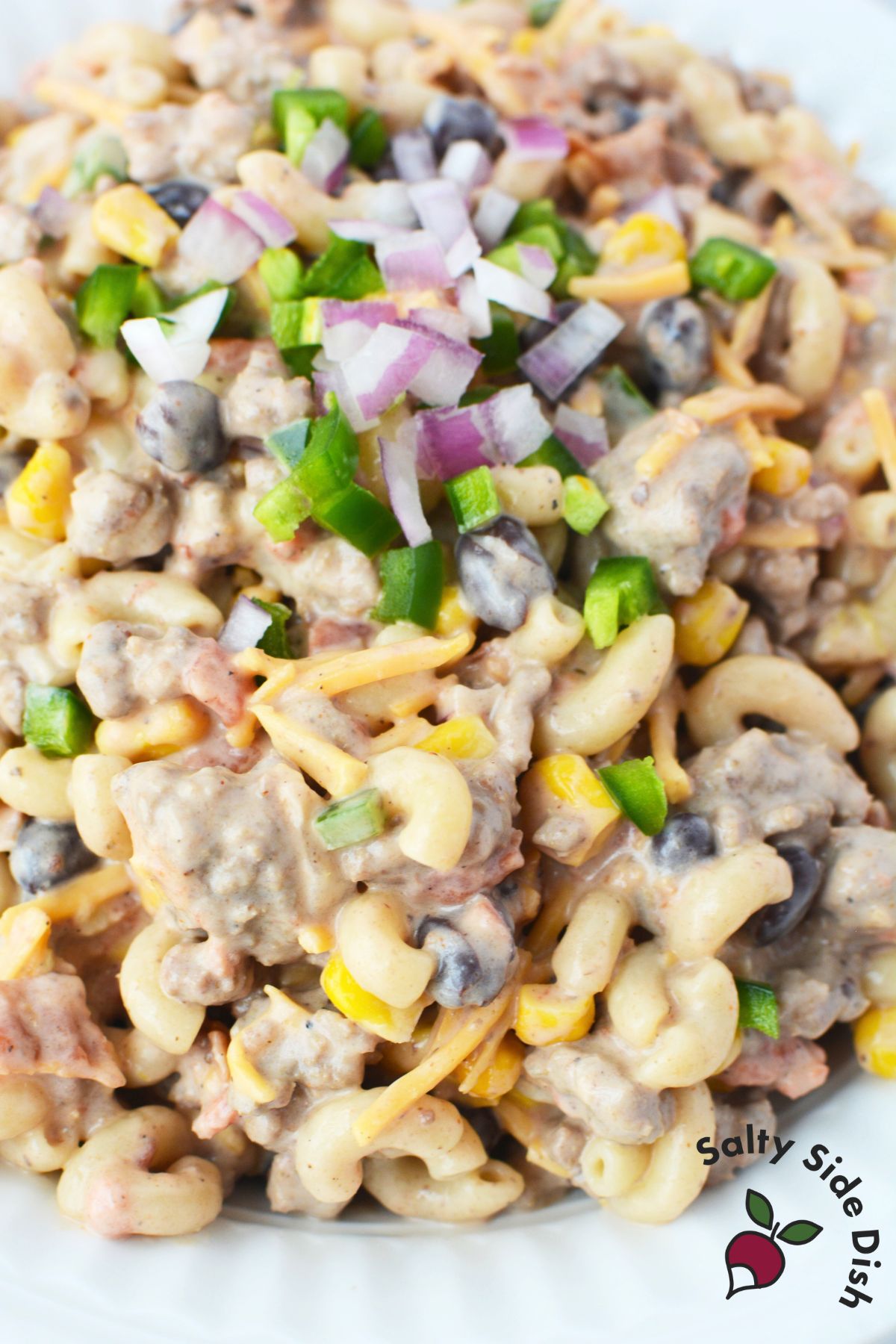cowboy pasta salad in a white bowl ready to be served as a unique side dish recipe.