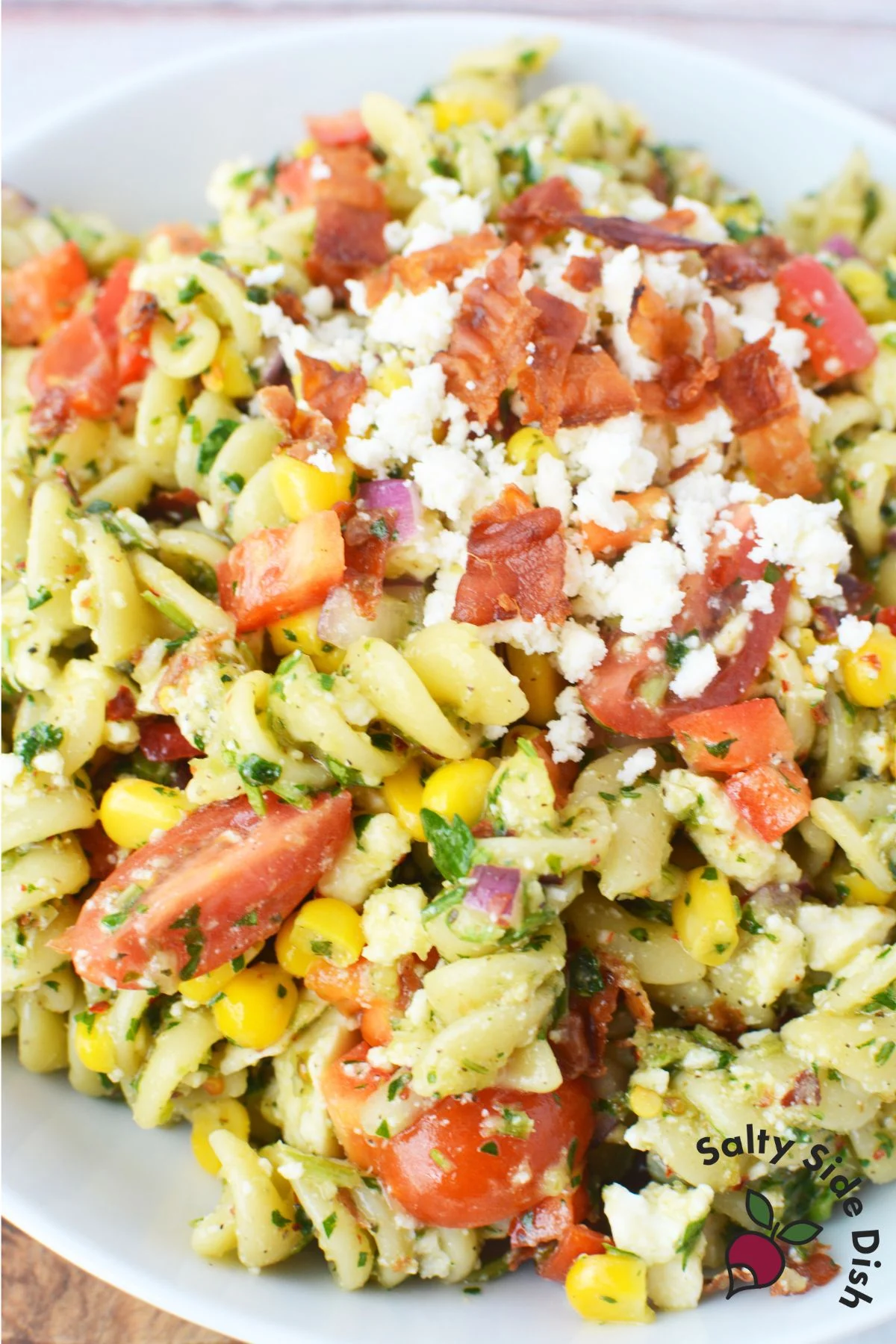 topping of cheese and bacon on this summer pasta salad.