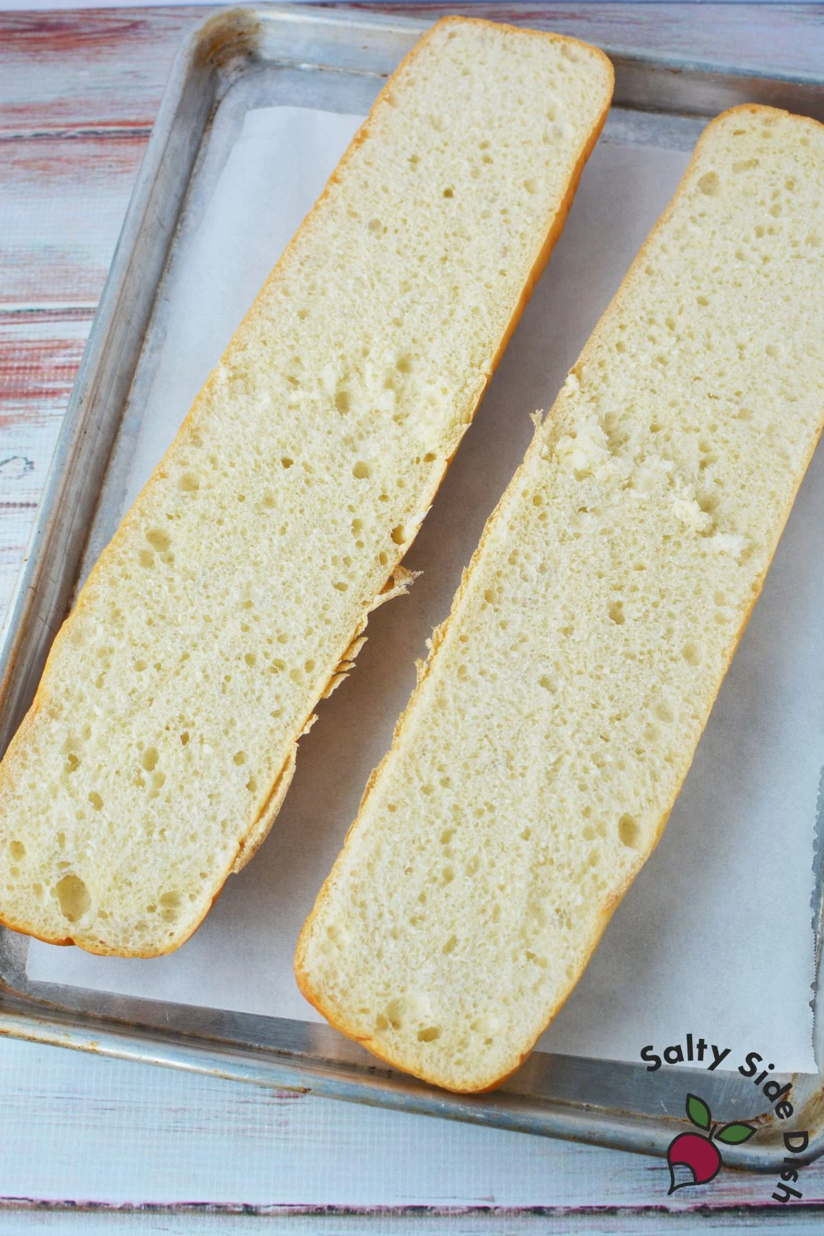 sliced french bread on a baking sheet.