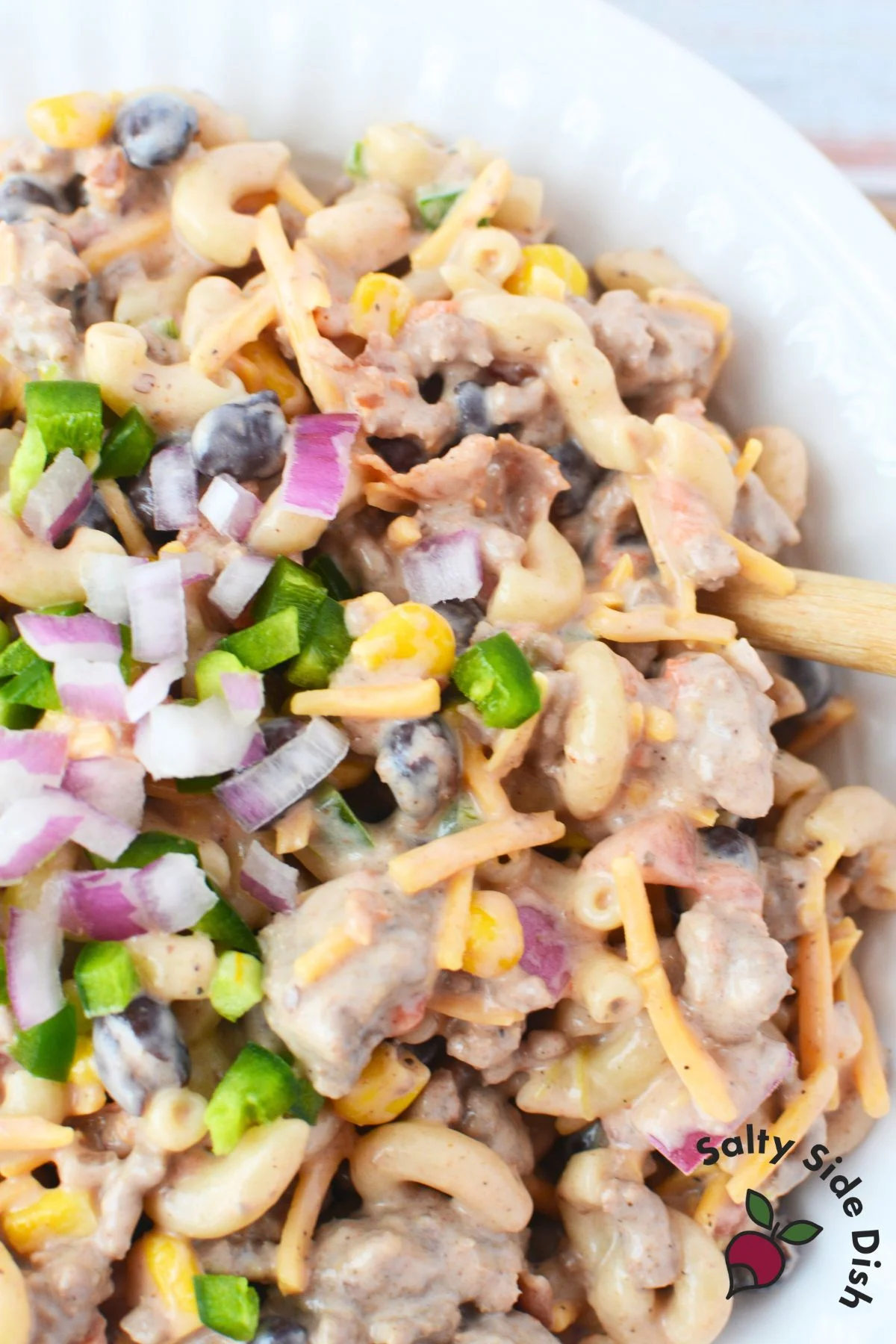 Close-up of creamy BBQ pasta salad with beef and beans.