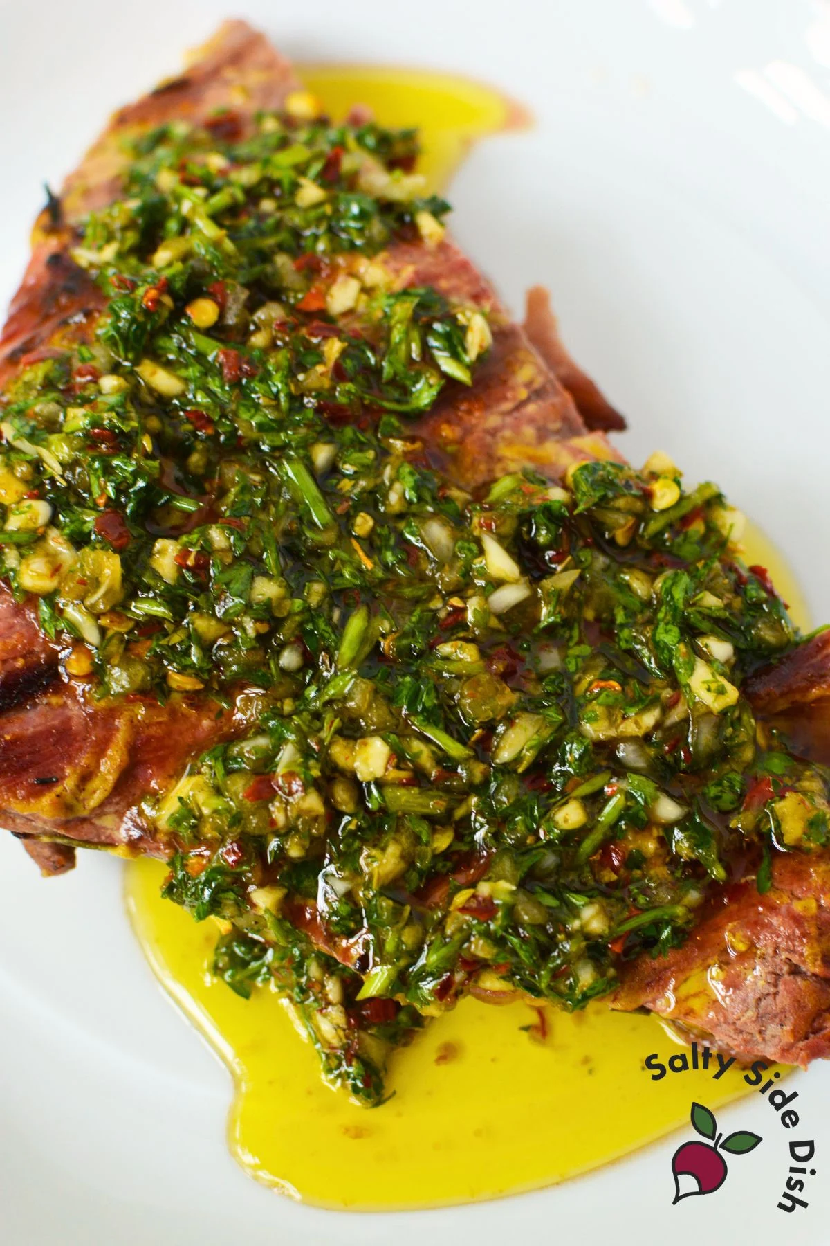 chimichurri smothered over a steak.