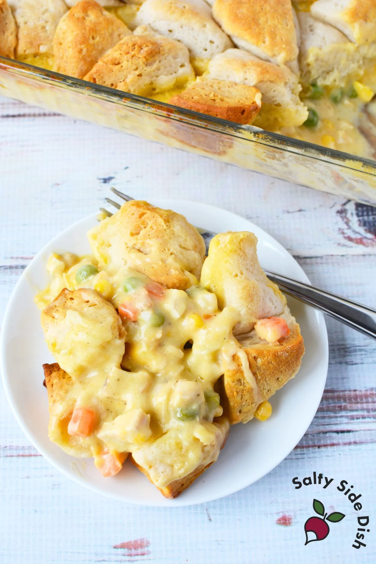 Serving of biscuit-topped chicken pot pie on a white plate.