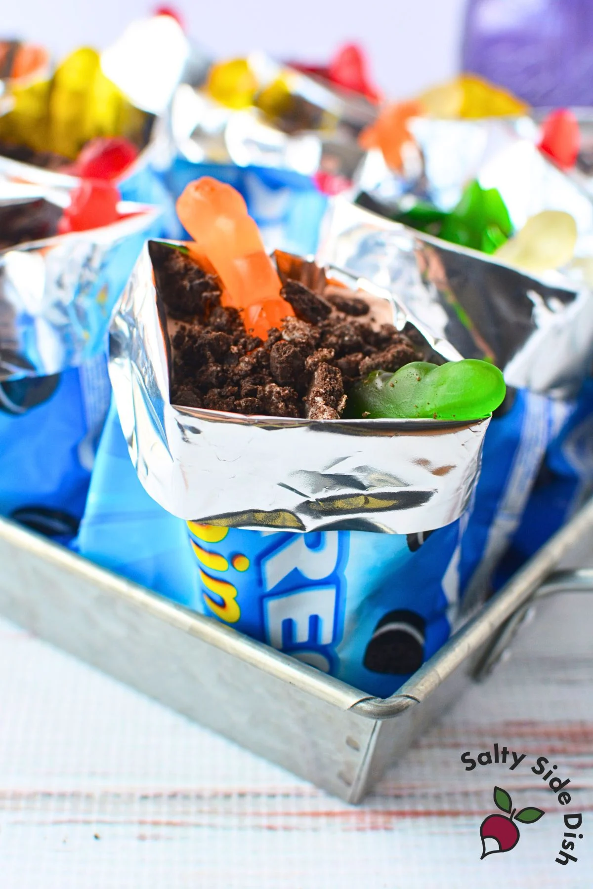 Side angle of a single Oreo snack bag dessert showing layered pudding and toppings.
