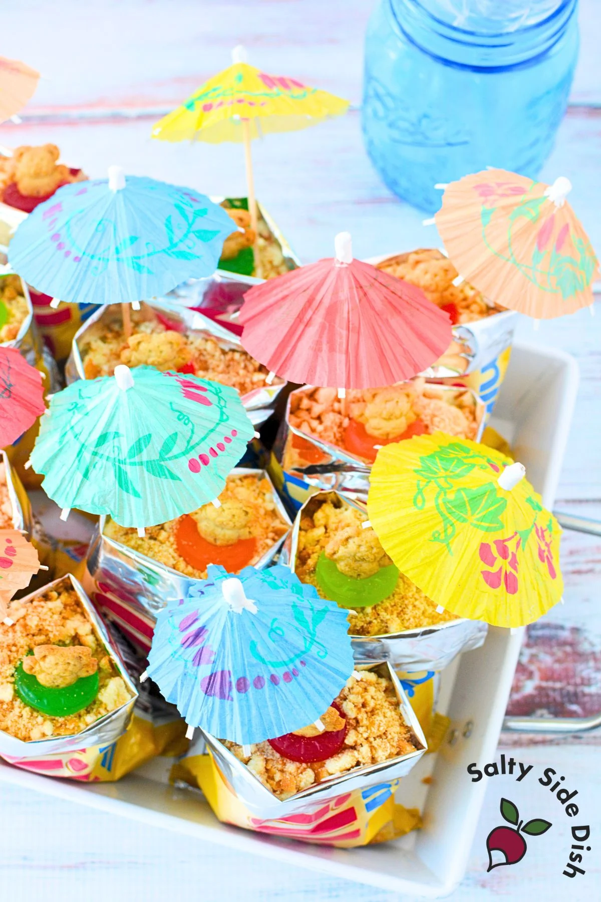 Colorful tray of walking beach pudding bags with mini umbrellas