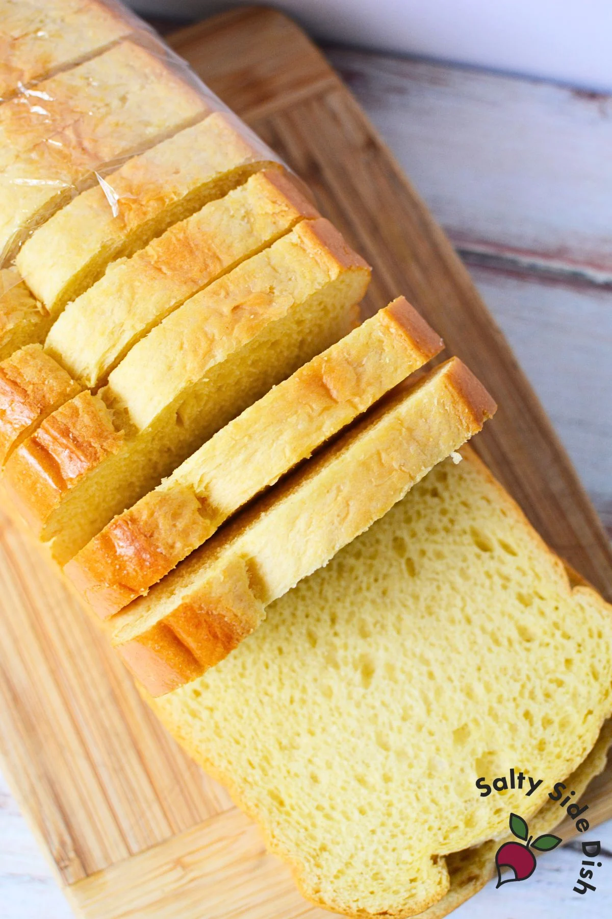 Sliced brioche bread on cutting board, perfect for making brioche French toast with thick, buttery slices.
