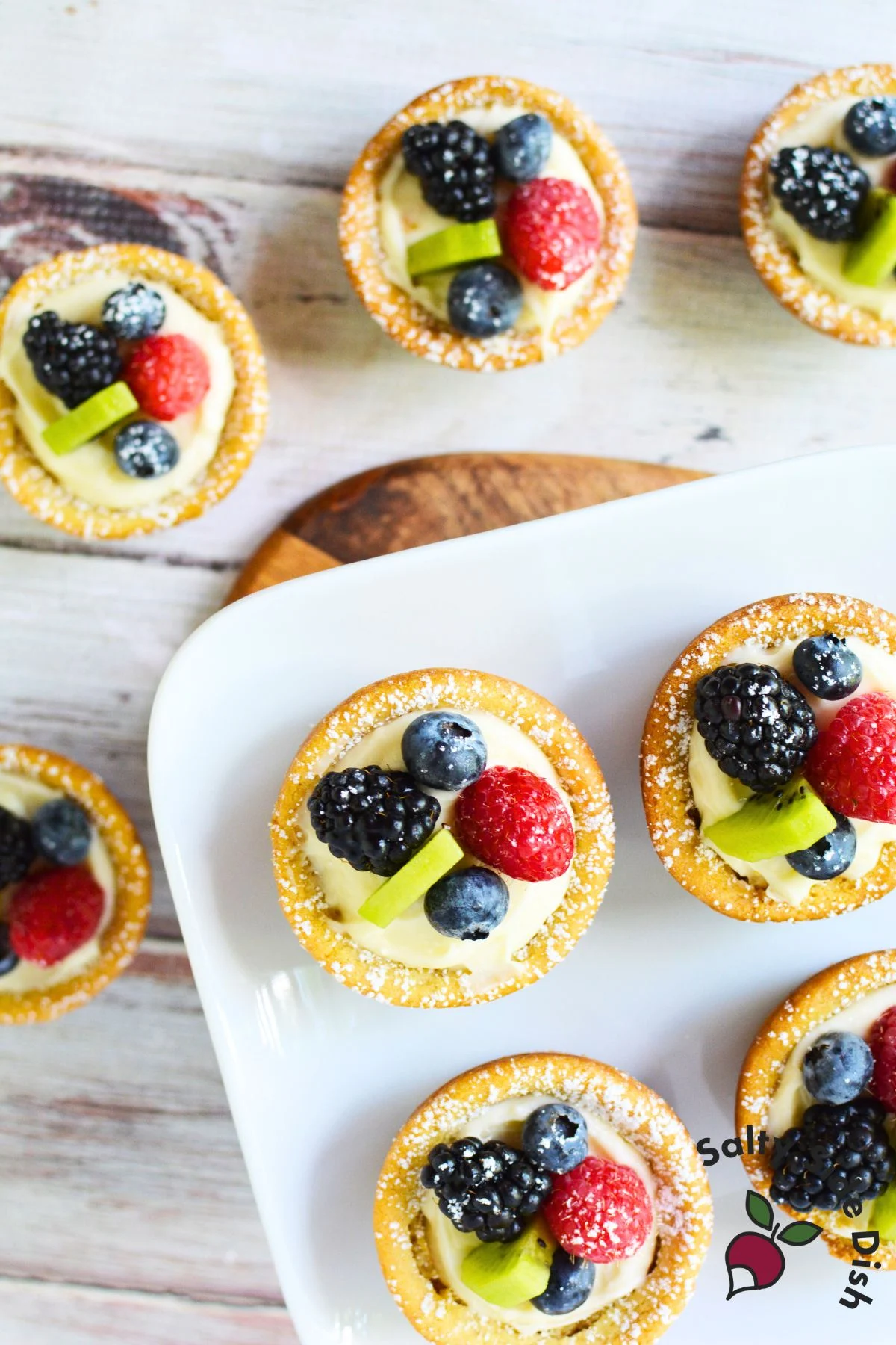 Finished fruit sugar cookie cups topped with fresh berries and kiwi