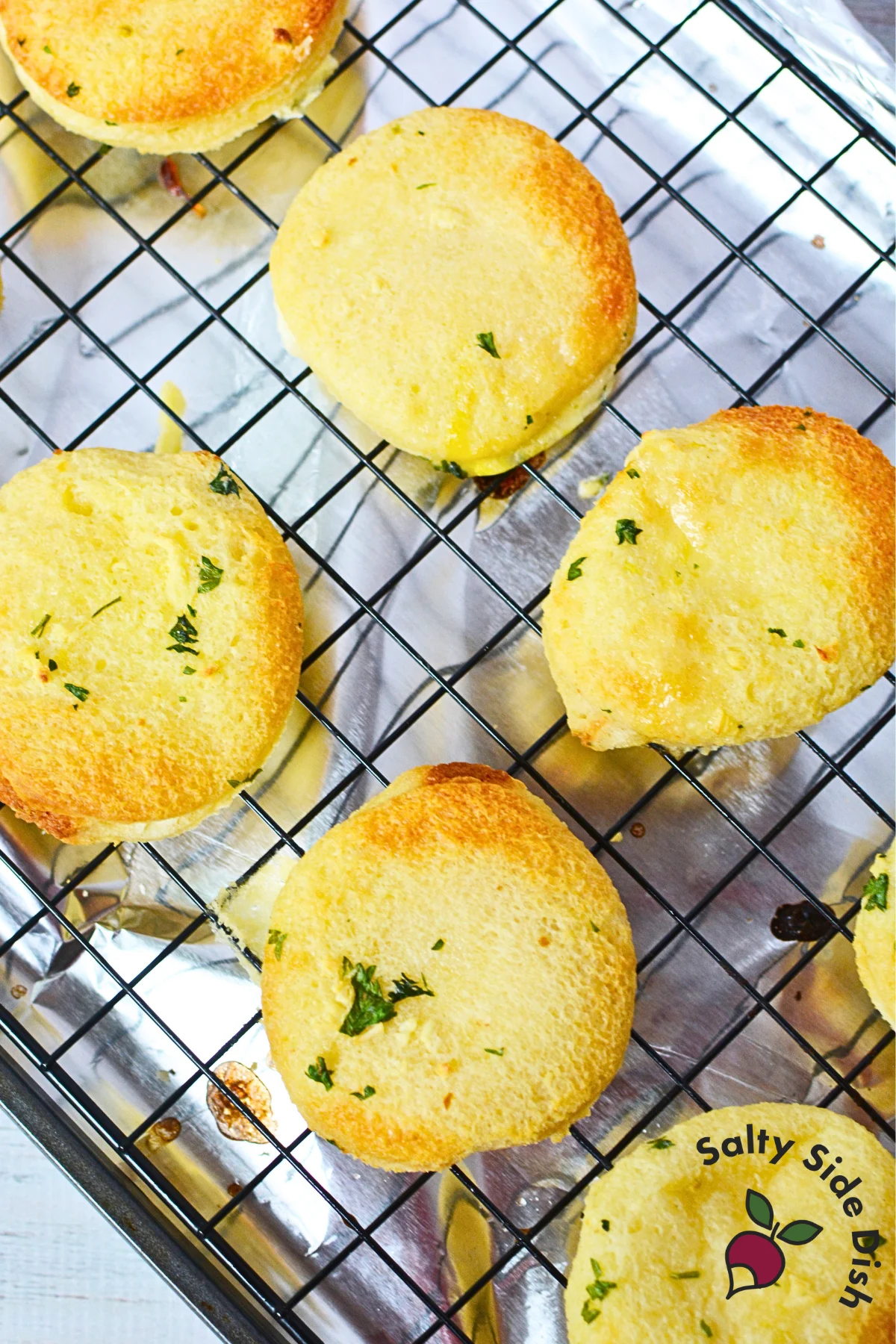wire rack with golden garlic discs from the oven.