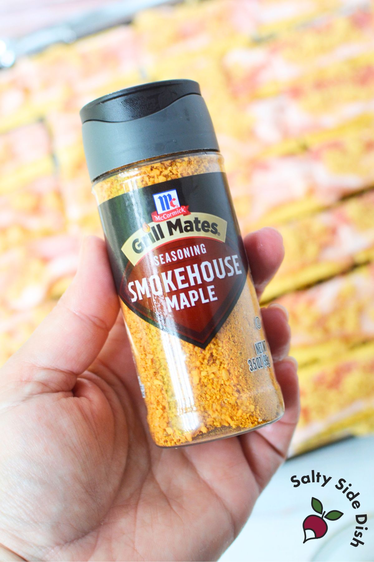 McCormick Smokehouse Maple seasoning held over bacon crackers in the background