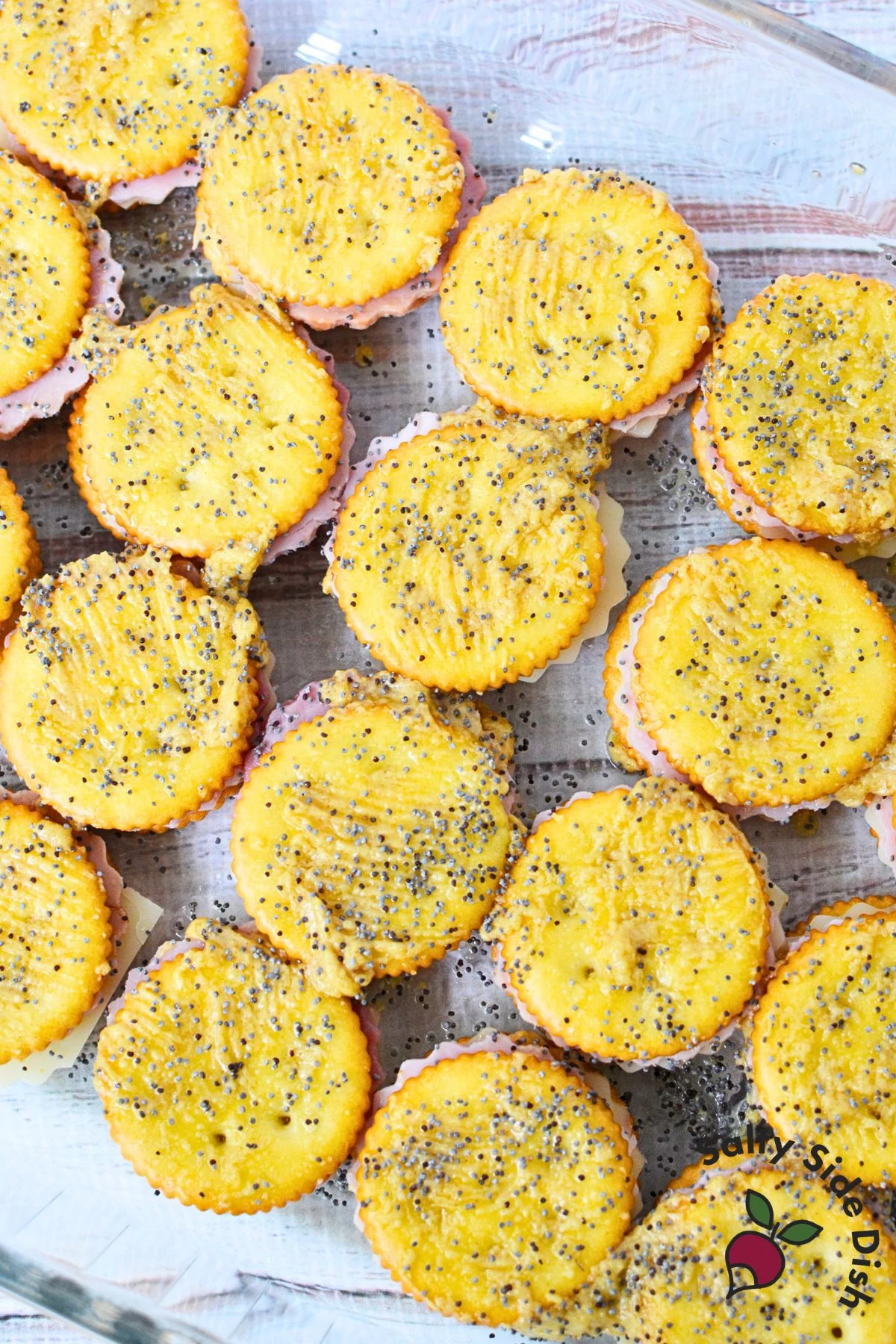 Baked Ritz cracker snacks with melted cheese and buttery mustard topping close-up.