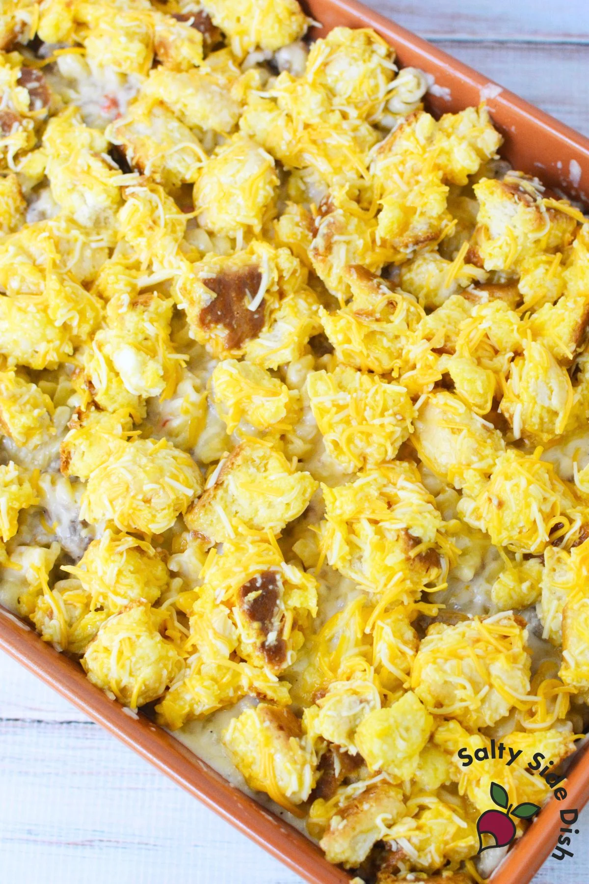 breakfast sausage pasta bake with golden brown biscuit topping right out of the oven