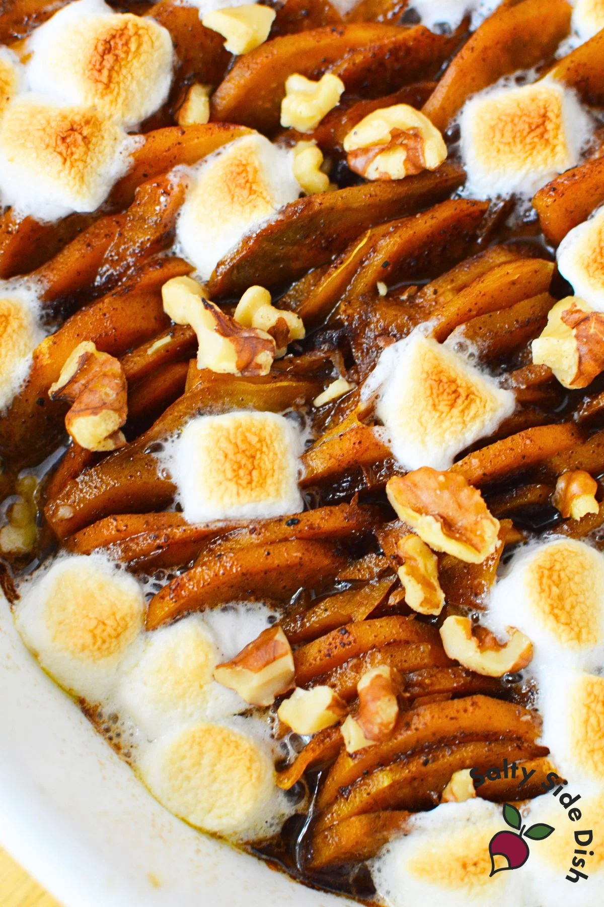 Scalloped sweet potatoes layered with marshmallows and walnuts for Thanksgiving
