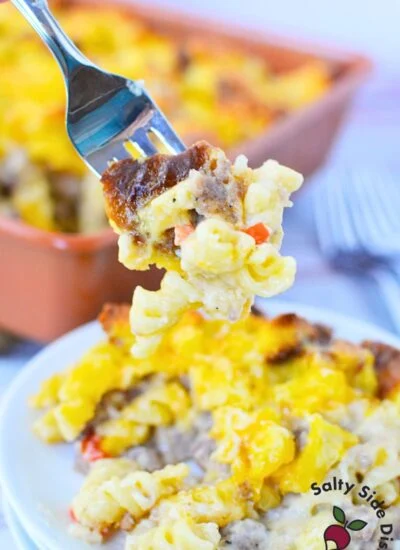 forkful of sausage pasta bake with pasta, sausage, cheese, and biscuit topping