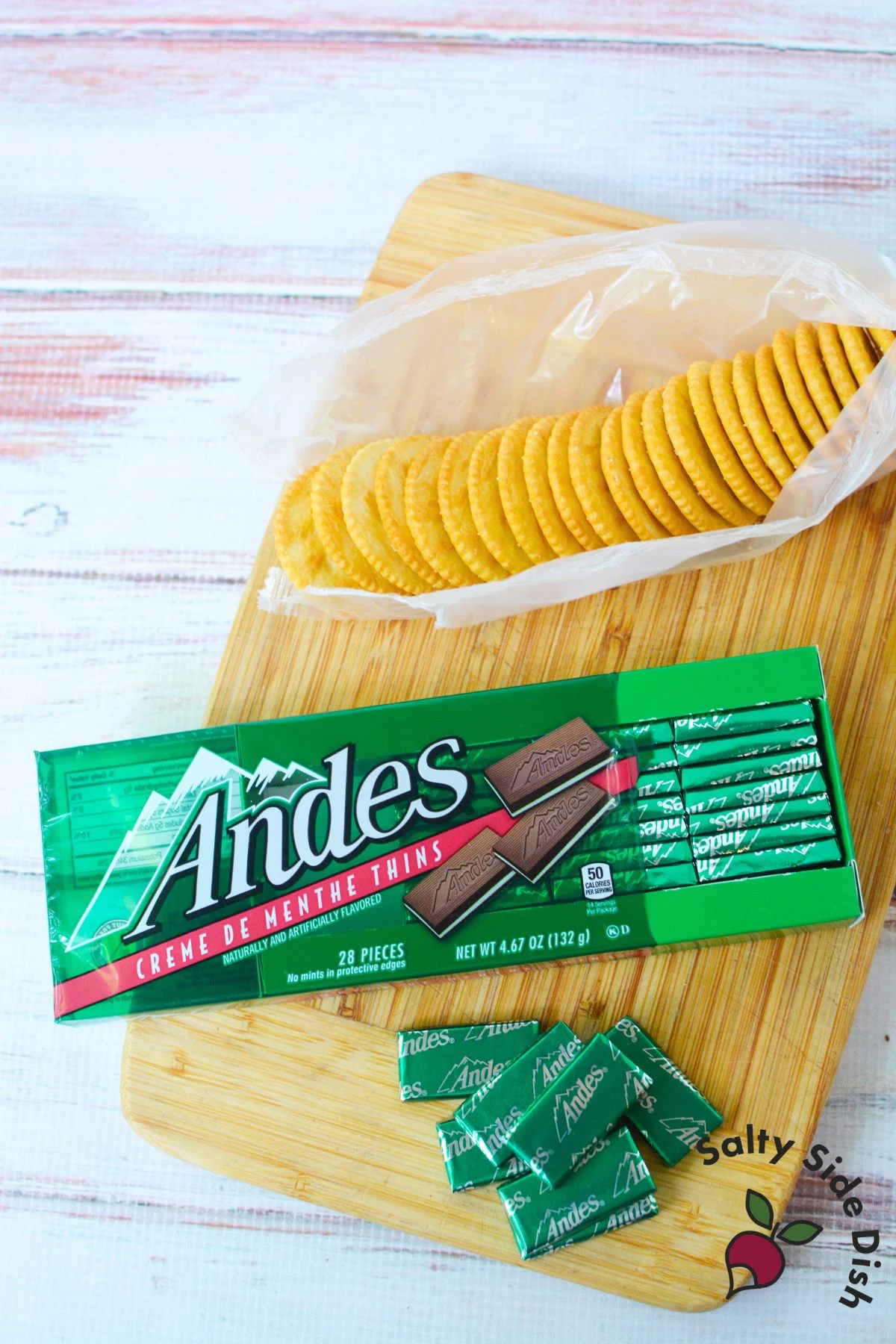 Package of Andes crème de menthe chocolates and sleeve of Ritz crackers on cutting board