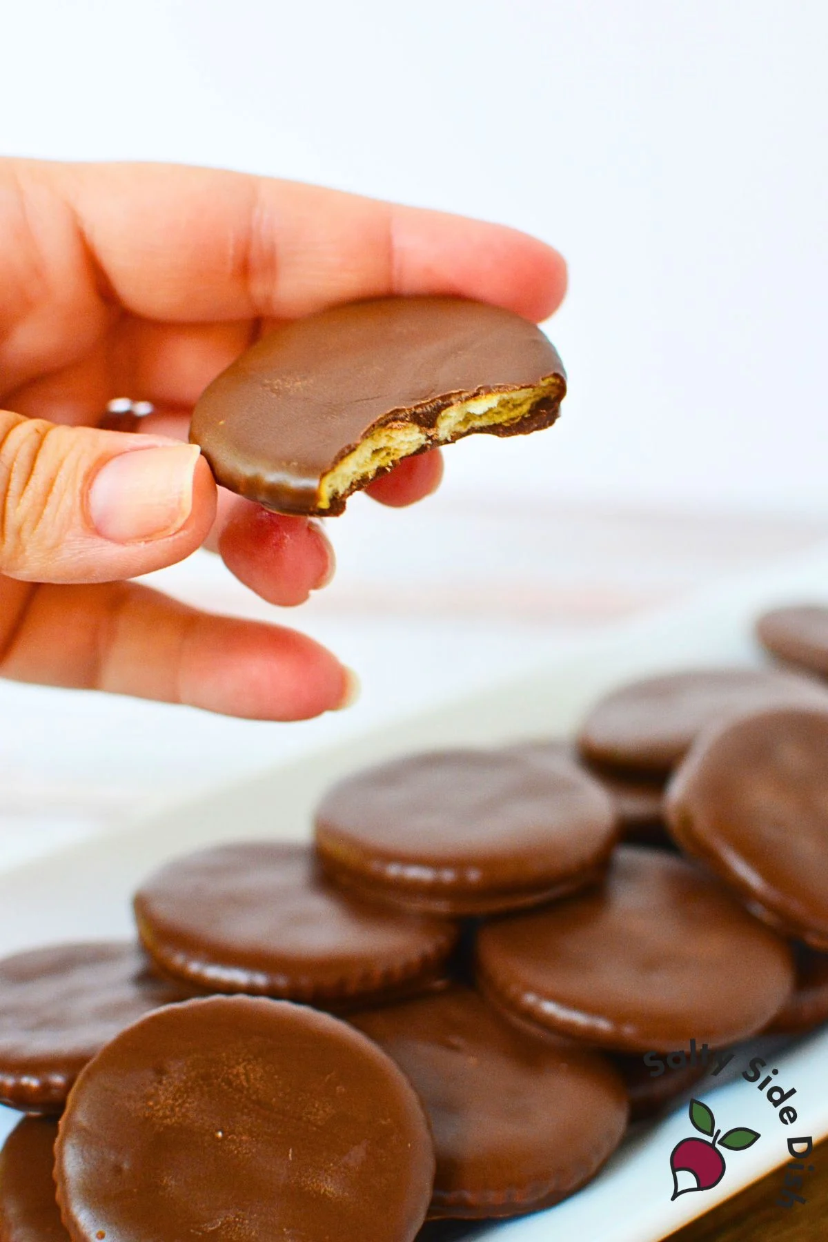 Homemade Thin Mint cookie with bite showing Ritz cracker center