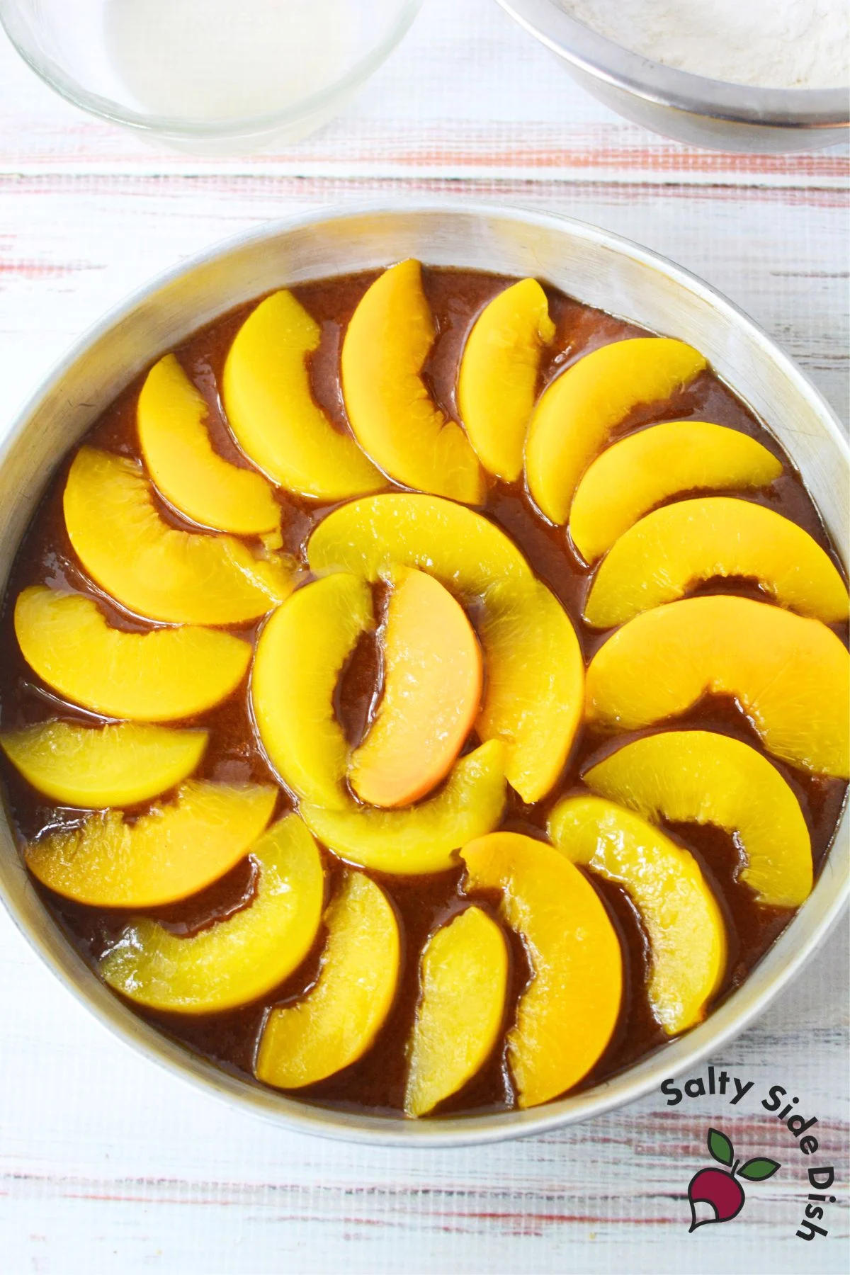 Sliced canned peaches arranged neatly for upside down cake topping