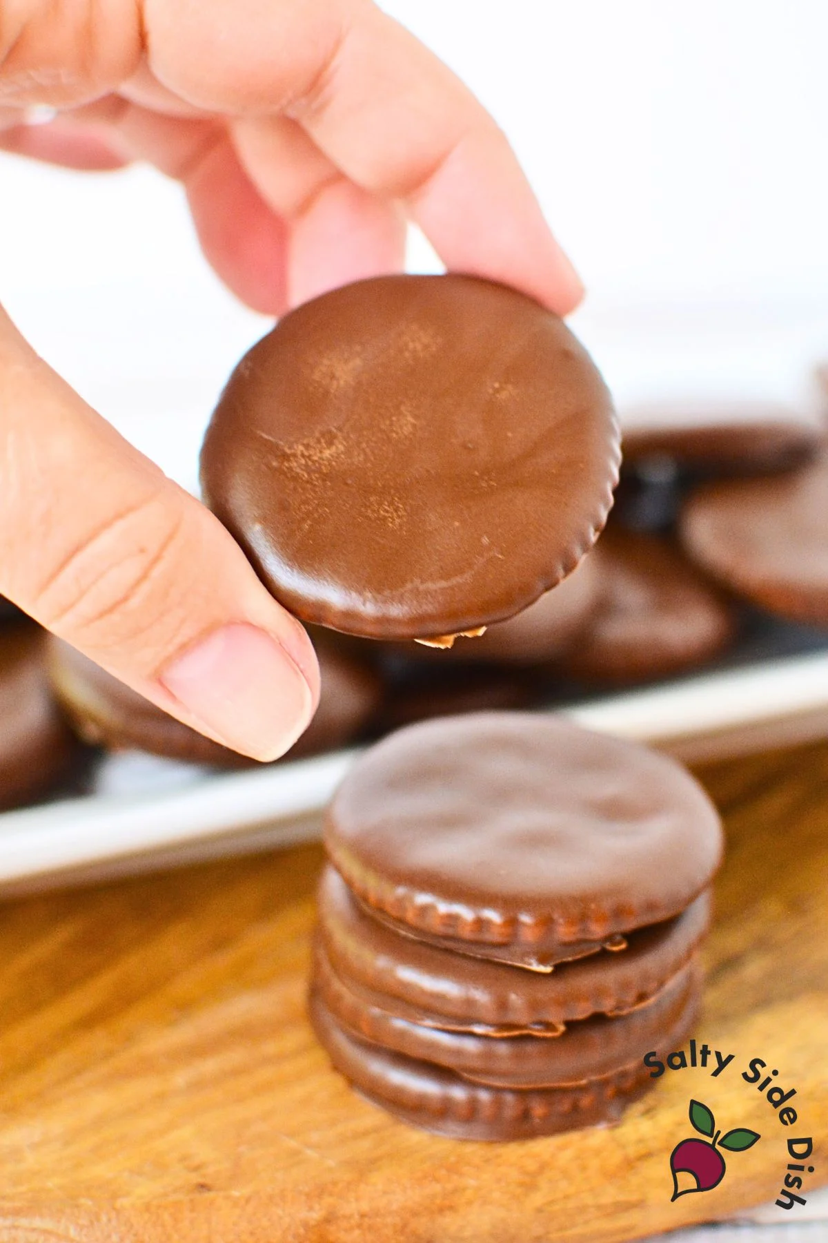 Hand holding a finished homemade Thin Mint cookie