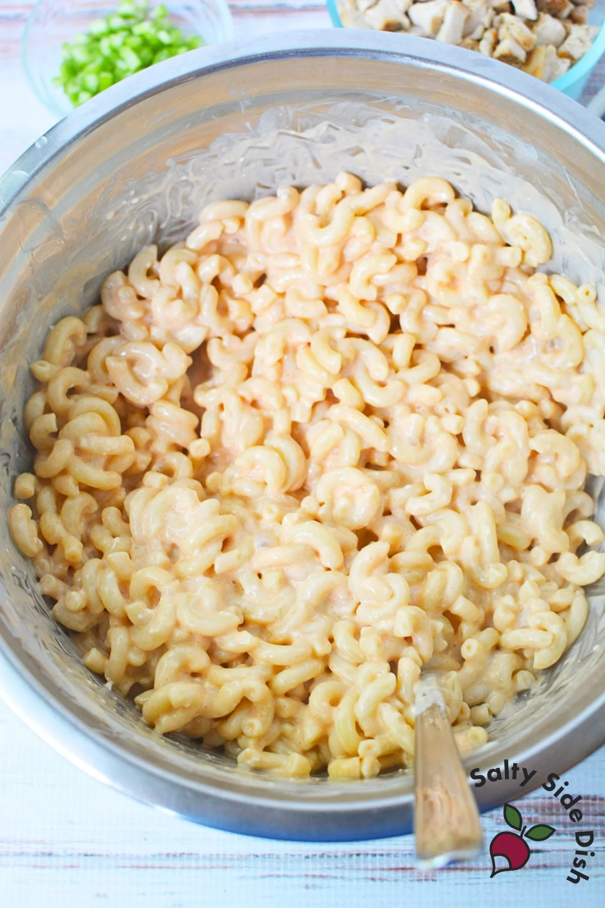 Elbow macaroni coated in buffalo sauce, cream cheese, ranch, and sour cream mixture for pasta salad