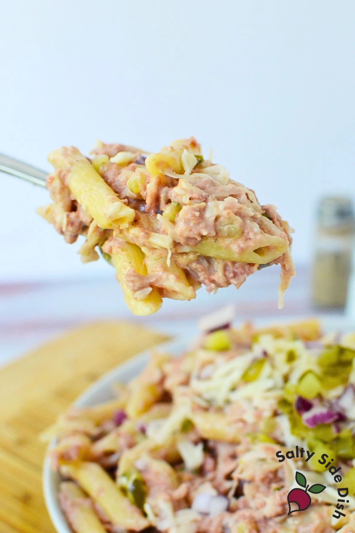 Spoonful of creamy Reuben pasta salad with pasta, corned beef, pickles, and Swiss cheese.