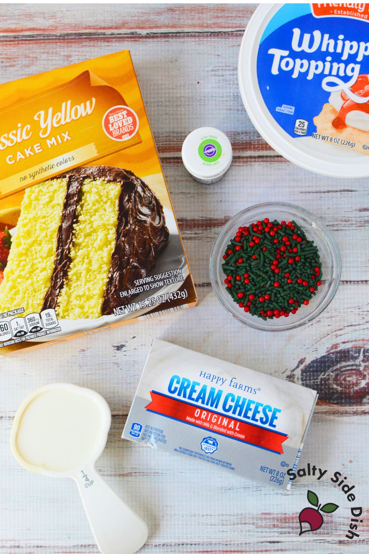 Ingredients for easy Christmas dip with yellow cake mix, cream cheese, whipped topping, milk, and sprinkles