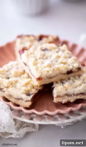 Luscious Caramel Apple Crumble Bars 3 Crumb-topped strawberry jam shortbread bars on a pink plate, featuring a simple cookie bar recipe with strawberry jam filling.