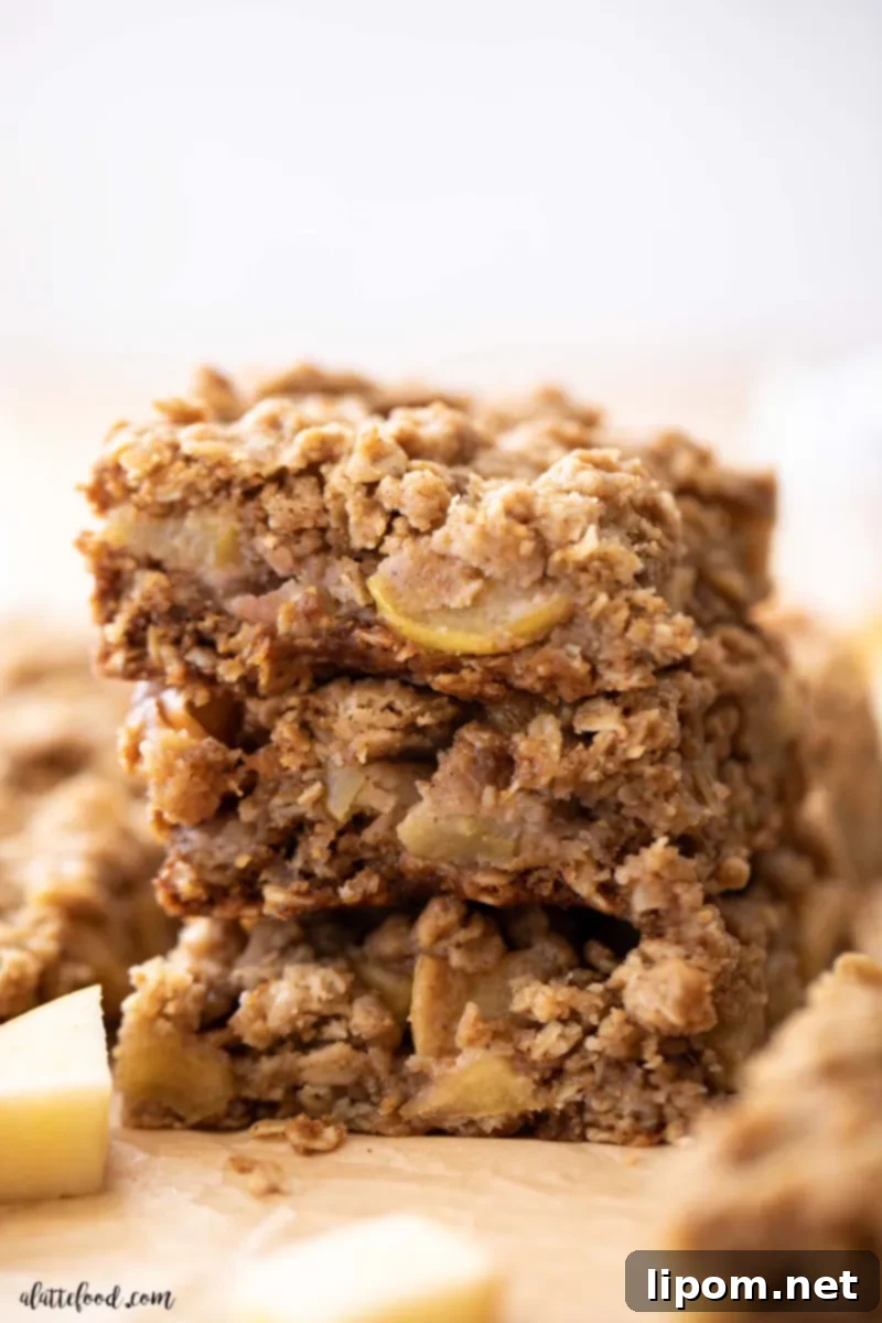 Stack of Delicious Caramel Apple Crumb Bars Stack of three apple crumb bars on brown parchment paper, featuring an easy brown sugar oat crust and a luscious caramel apple filling.