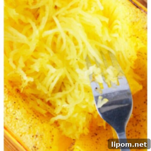 Spaghetti squash cooked and ready to be scraped into strands.