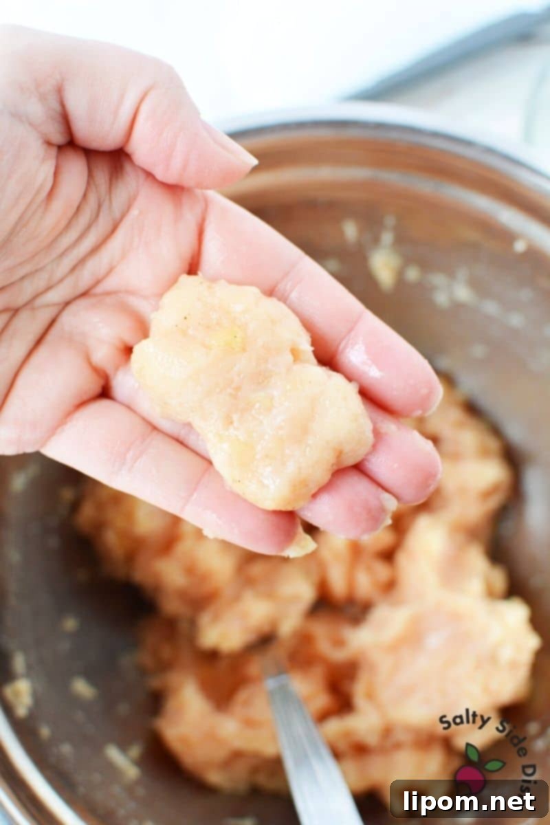 Crafting Homemade McDonald's Chicken Nuggets for a Viral Recipe Shaping ground chicken into iconic McDonald's McNugget forms with wet hands