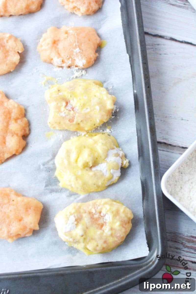 Double-Dipping for Extra Crispy Homemade McDonald's Nuggets Process of double-dipping frozen chicken nuggets in egg wash and flour mixture