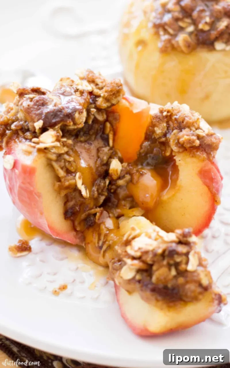 These Caramel Stuffed Baked Apples are topped with an oat brown sugar crust. These baked apples are filled with caramel candies and baked until the apples are soft, the caramel is gooey, and the topping is crisp and caramelized! #apple #dessert #recipe #fall #thanksgiving The best brown sugar caramel stuffed baked apples!