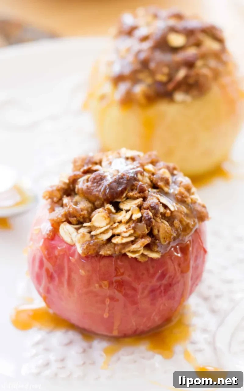 These Caramel Stuffed Baked Apples are topped with an oat brown sugar crust. These baked apples are filled with caramel candies and baked until the apples are soft, the caramel is gooey, and the topping is crisp and caramelized! #apple #dessert #recipe #fall #thanksgiving These caramel drizzled Caramel baked apples are topped with a brown sugar crust.