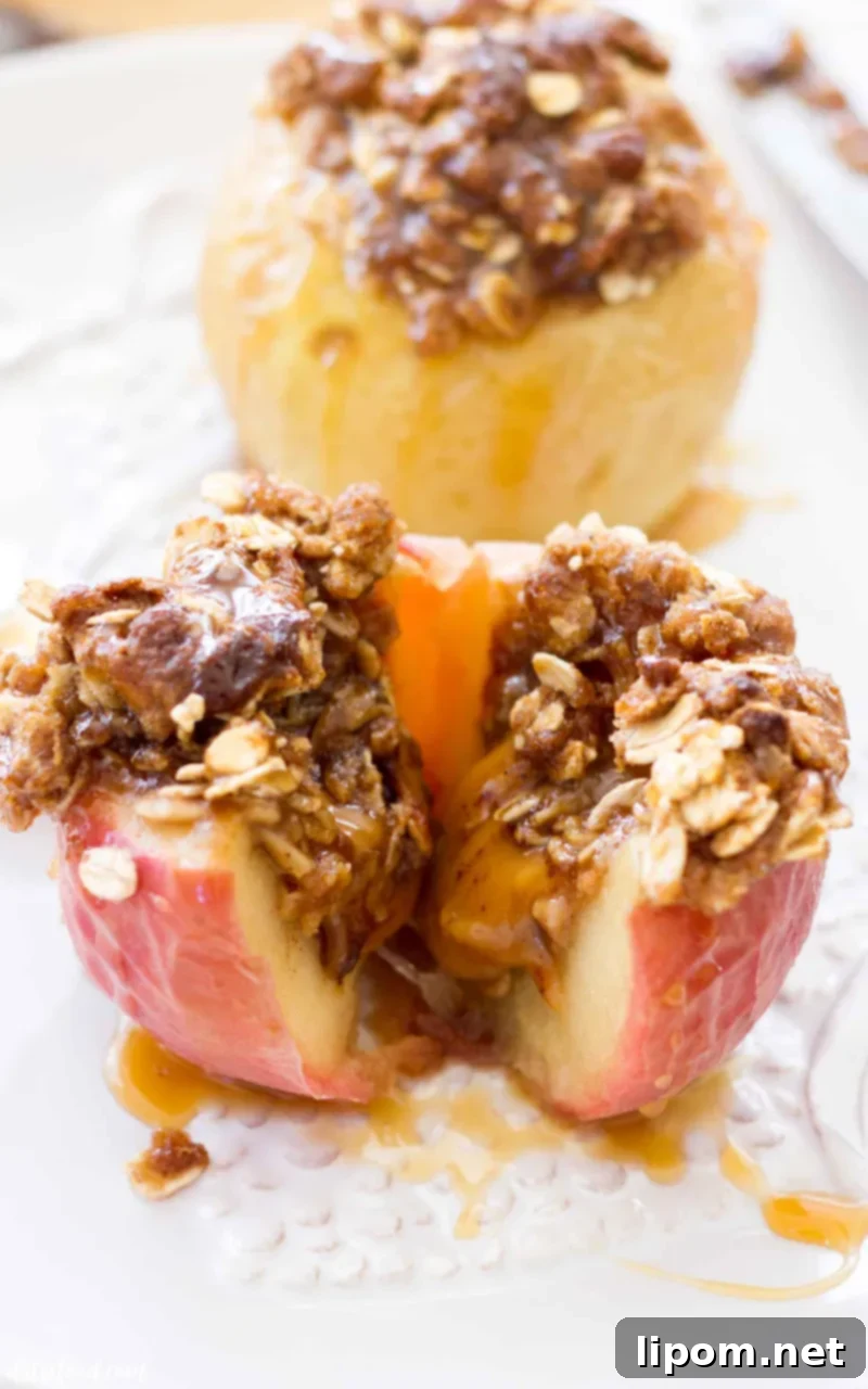 These Caramel Stuffed Baked Apples are topped with an oat brown sugar crust. These baked apples are filled with caramel candies and baked until the apples are soft, the caramel is gooey, and the topping is crisp and caramelized! #apple #dessert #recipe #fall #thanksgiving Gooey caramel stuffed baked apples are sweet, rich and perfect for fall.