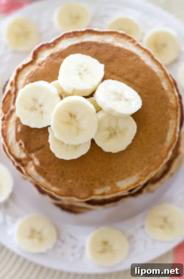 Cloud-Like Honey Banana Pancakes 4 Fluffy honey banana pancakes stacked high, ready to be served