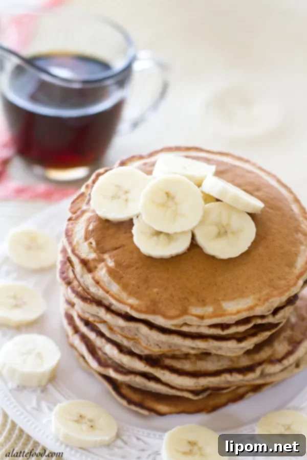 Cloud-Like Honey Banana Pancakes 5 A stack of golden brown honey banana pancakes, ready to be drizzled with syrup