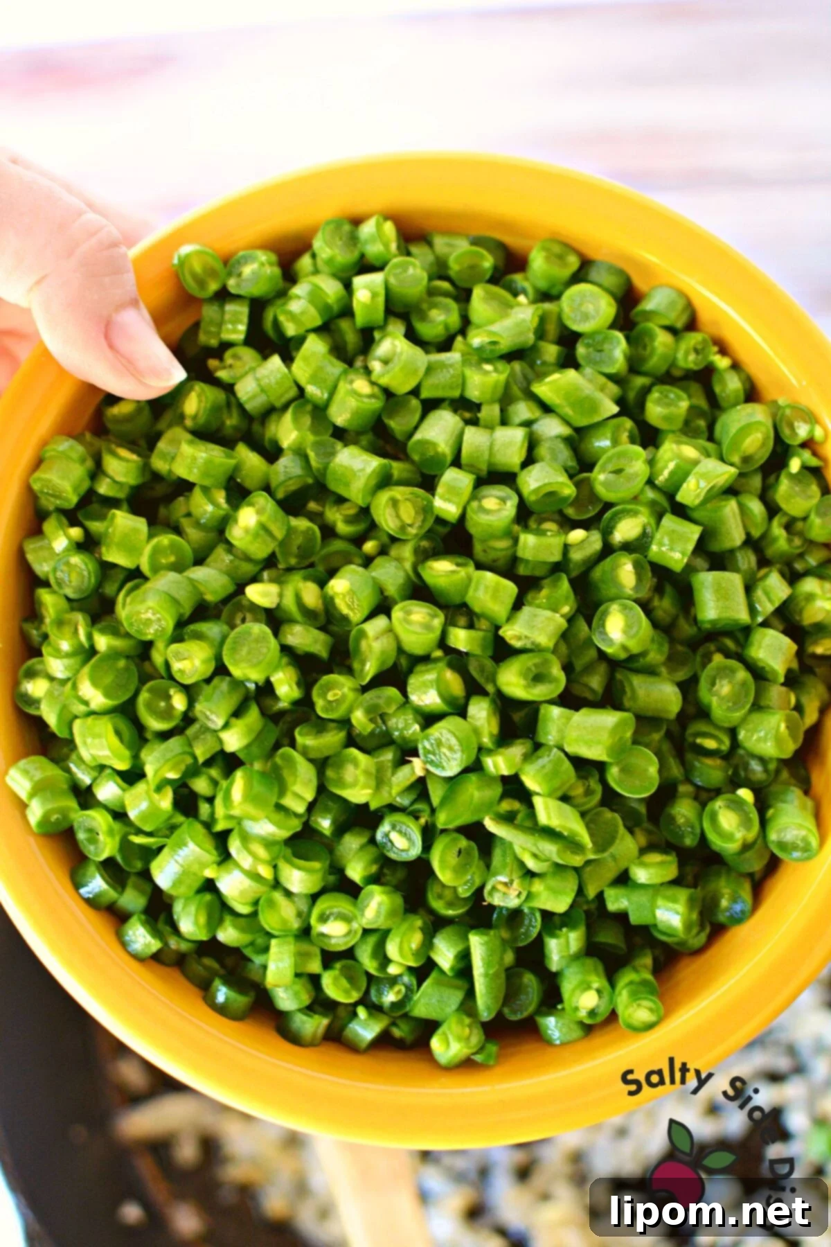 Bite-Sized Green Beans 4 Bowl of freshly diced green beans, ready for cooking, highlighting their uniform small size.