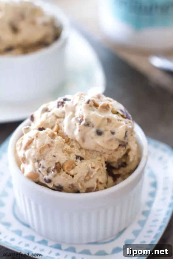 This creamy peanut butter ice cream is swirled with ribbons of chocolate, peanut butter chips, and chocolate chips. It's a chocolate peanut butter dream! | www.alattefood.com