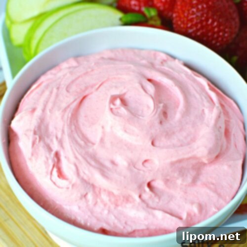 Luscious Strawberry Dip 11 Large bowl of creamy strawberry fruit dip, garnished with fresh strawberries, illustrating a delicious and easy dessert idea.
